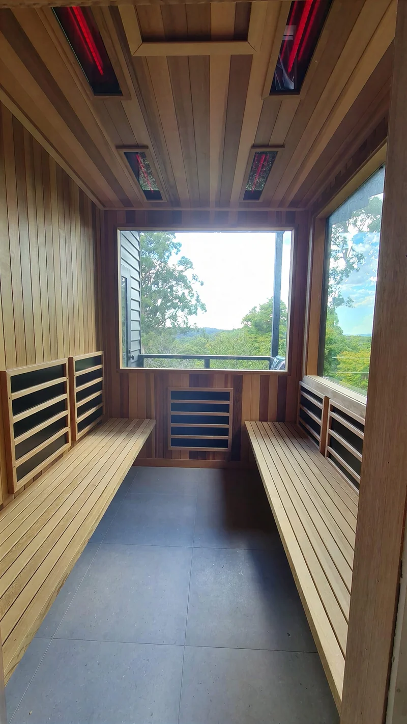 Sauna benches arranged beside a tall window